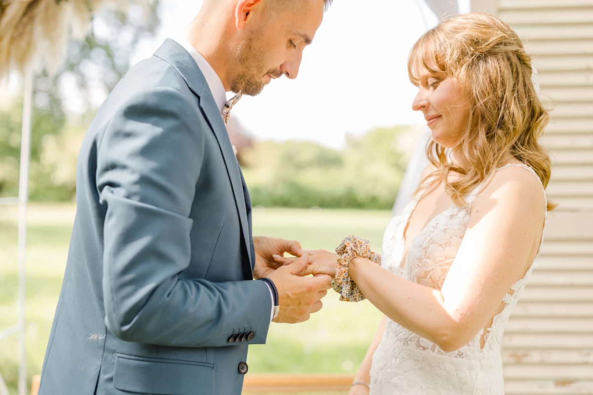 Échange des alliances entre mariés lors de la cérémonie laïque en extérieur